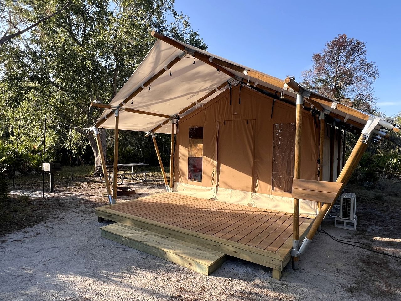 A tent-like structure with a wooden deck and a canopy.