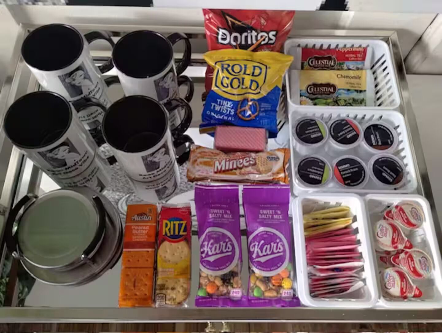A refrigerator stocked with various food items including chips, cookies, and condiments.