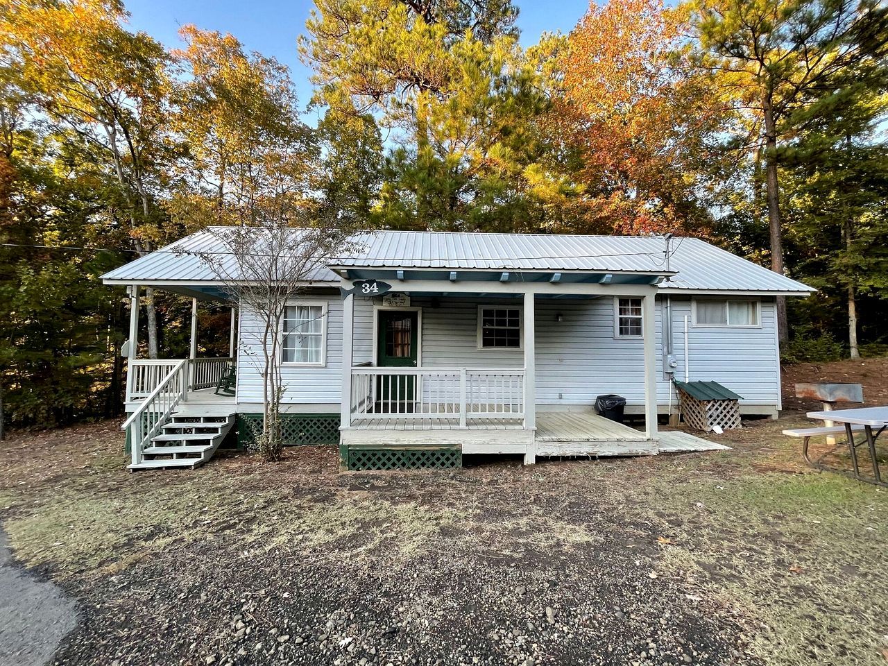 A single-story house with a porch, a small front yard, and a mailbox.