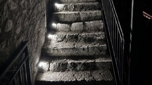 A stone staircase with metal railings, leading to a higher level. - Diak’s Tower | Sunset Sea View in Mani (Charia)