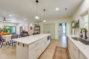 A spacious kitchen with a large island, white cabinetry, and pendant lighting. - Deck & Fire Pit! Mtn Escape, 12 Mi to Asheville (Leicester)