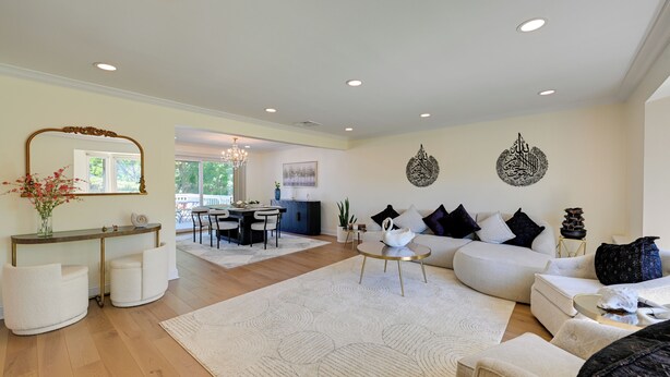 A spacious living area with a sofa, a coffee table, and a dining table. - Easy NYC Commute! Home 1 Mi to Dtwn Westbury (Westbury)