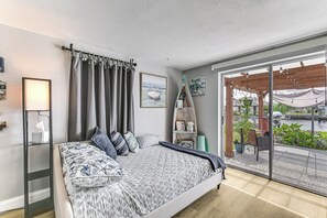 A bedroom with a large bed, a view of the outdoors, and a wooden pergola. - Boat Dock Access! Pet-friendly Studio in Hudson (Hudson)