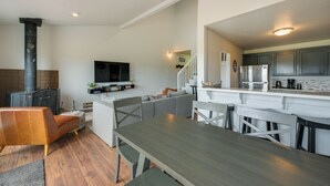 A modern kitchen with white cabinets, a built-in oven, and a stainless steel refrigerator. - Lake + Mountain Views! Pagosa Springs Getaway (Pagosa Springs)