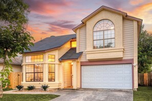A two-story house with a garage, large windows, and a tree in the front yard. - Private Pool! Family Getaway, 5 Mi to Seaworld (San Antonio)
