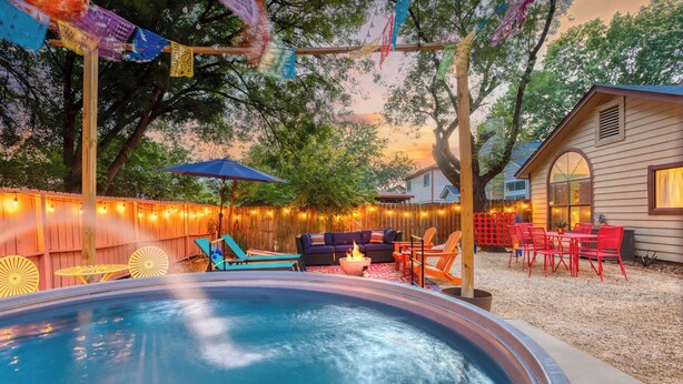 A backyard with a swimming pool, outdoor furniture, string lights, and a small building. - Private Pool! Family Getaway, 5 Mi to Seaworld (San Antonio)