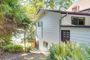 A house with a sloped roof, a front door, and a window.