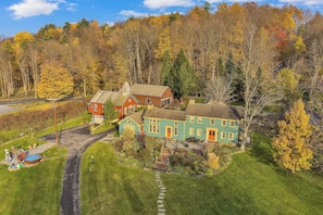 A large house with a garage, a swimming pool, and a well-maintained lawn.