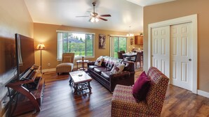 A living room with a sofa, a patterned armchair, a coffee table, a TV, and a ceiling fan. - 4 Mi to Dtwn! Columbia Falls Home w/ Spacious Yard (Columbia Falls)