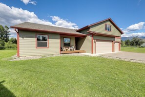 A two-story house with a garage, a covered porch, and a well-maintained lawn. - 4 Mi to Dtwn! Columbia Falls Home w/ Spacious Yard (Columbia Falls)