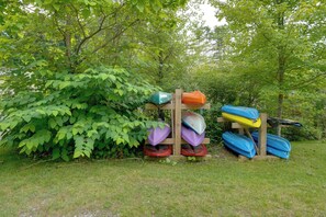 A wooden structure with kayaks and a paddleboard. - Walk to the Water! Lake George Family Getaway (Town of Putnam)