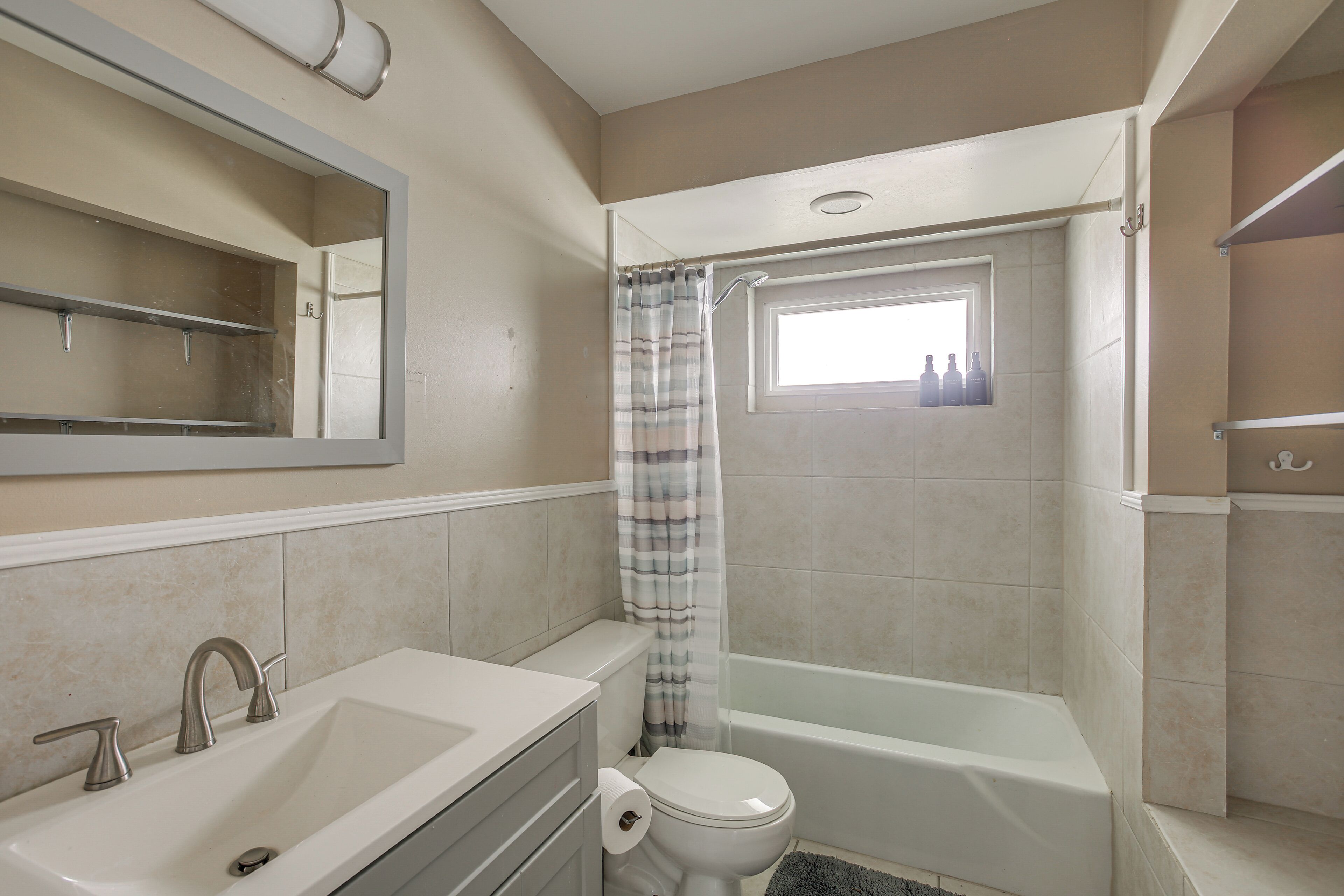 A bathroom with a sink, toilet, and bathtub.