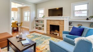 A living room with a fireplace, a television, and a sofa. - Bring Your Pets! Phoenix Family Getaway w/ Patio (Phoenix)