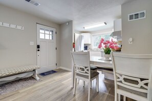 A kitchen with white cabinetry, a bench, and a dining area with two chairs. - Half-mi to Independence Square! Home w/ Ramp Entry (Independence)
