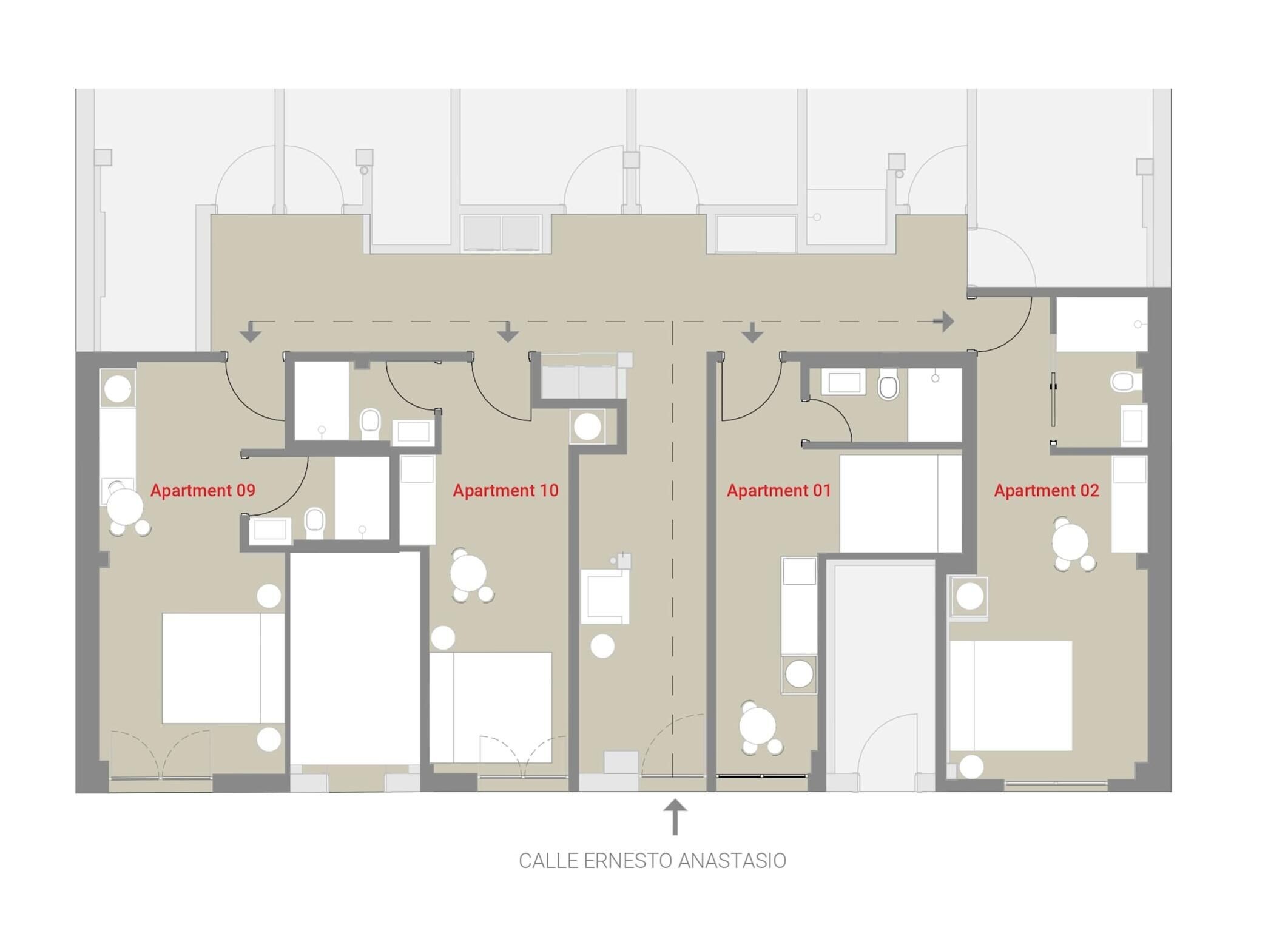 A floor plan of a building with four apartments, each with a bathroom, a living area, and a kitchen.