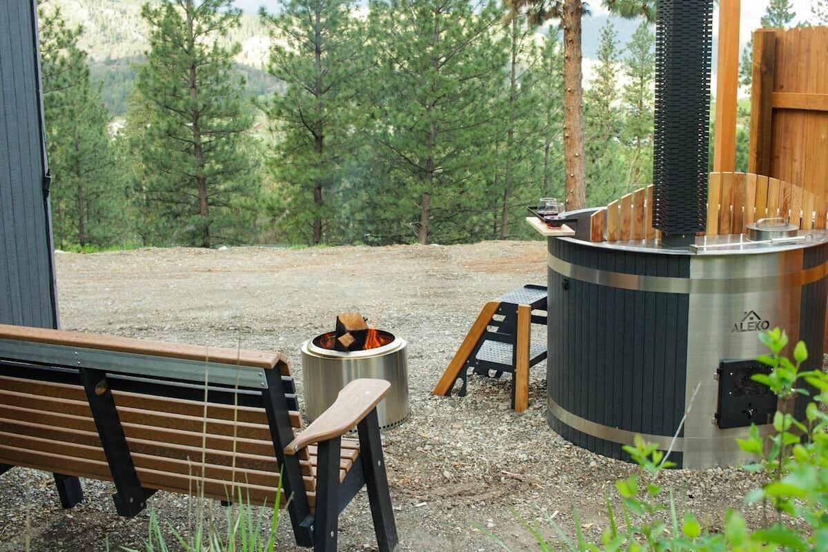 An outdoor seating area with a bench and a portable stove.