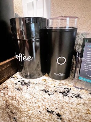 Two black tumblers with 'Coffee' and 'Mr. Coffee' branding on a kitchen counter. - Tropical Beach Spa Studio, Jacuzzi, Kitchen, WiFi (Sparks)
