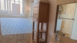 A bathroom with a large window, a shower, a wooden vanity with a sink, and a mirror. - Cozy house with a garden and pool in Carpentras (Carpentras)