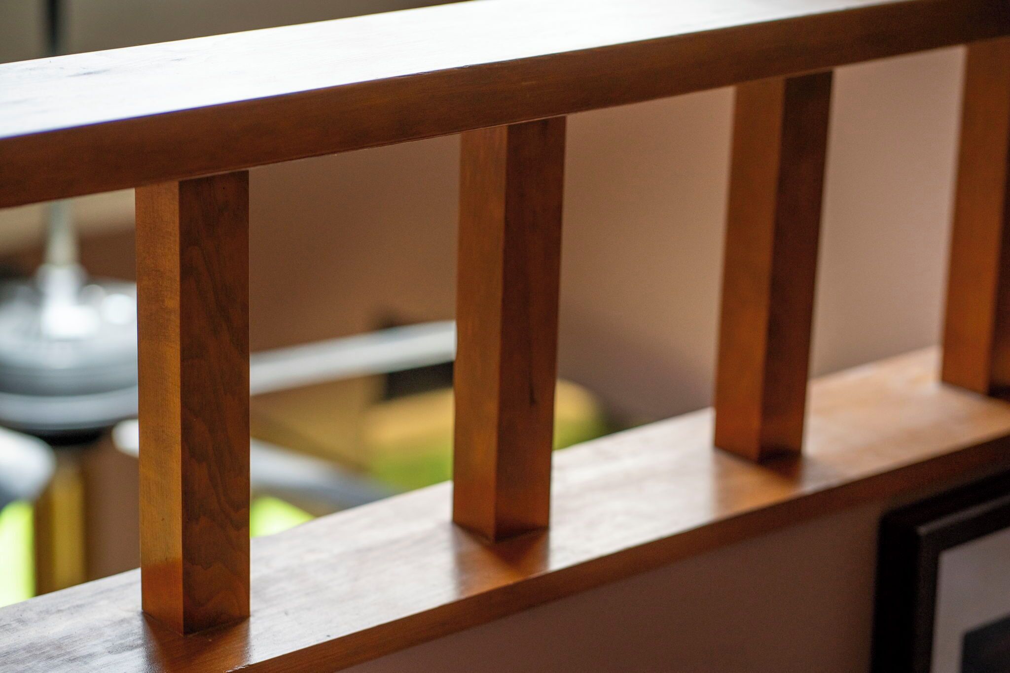A wooden railing with vertical slats.