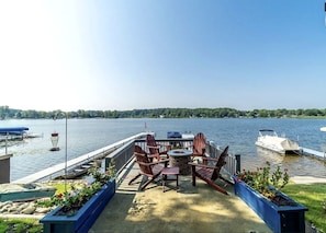 A docked boat, outdoor seating, and a view of the lake.