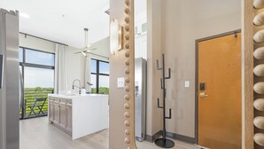 Una cocina moderna con una isla grande, vistas al exterior y una puerta de diseño único.