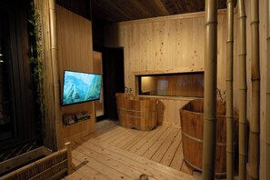 A wooden interior with a television, wooden tubs, and bamboo elements. - Exclusive Whole-House Ryokan in Sapporo | Features a Japanese Garden, Open-Air Bath, and Sauna / Accommodates up to 16 Guests: 10-minute walk from Subway 27-jo Station (札幌市)