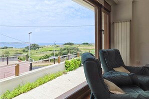 A balcony with a view of a green landscape and a body of water. - Disconnect in Galicia: A Journey to the Sea (Pontevedra)