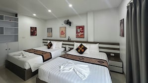 A hotel room with two beds, a ceiling fan, a coffee-themed wall decoration, and a window with curtains. - Hanoi Homestay Minh Nhat (Hanoi)