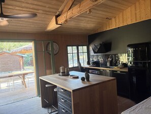 A kitchen with wooden beams, a built-in oven, and a sink. - House at the Foot of the Dune (Lège-Cap-Ferret)