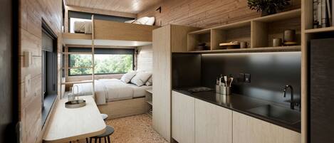 Cocina compacta con comedor, estantes integrados y ventana con vista a zonas verdes.