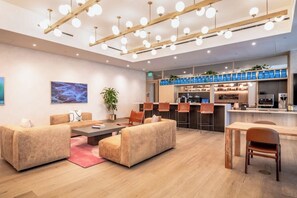 Un intérieur moderne avec des canapés, une table à manger et un coin cuisine.