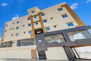 A multi-story building with a sign reading 'TOWNHOUSE.' - Deluxehennur Prakruthi Layout Bangalore (Bengaluru)
