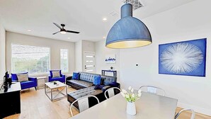 Un salon moderne avec un canapé, une table basse et une table à manger.