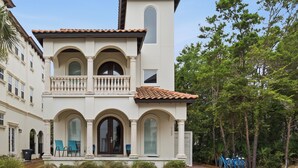A two-story building with a balcony, arched windows, and a tiled roof. - Bikes, Gated Community, New Rental, Golf Cart, Hot Tub, Close to Beach (Santa Rosa Beach)