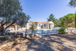A villa with a swimming pool, outdoor seating, and a garden. - Charming Villa “Maison Piscine et Nature” with Private Pool, Terraces, and Garden (Le Château-d'Oléron)