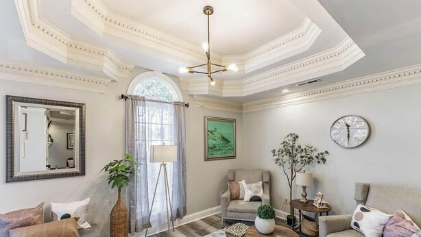 A room with a high ceiling, a large mirror, a window with curtains, a clock, and a sofa. - Spacious 3BR 3BA 5 bds Decatur Townhouse (Decatur)