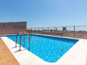 A rooftop swimming pool with clear blue water, metal pool ladders, and a view of the cityscape in the background. - Benicarlo Center by Interhome (Benicarló)
