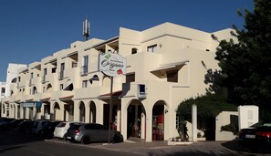 A multi-story building with a pizzeria bar on the ground floor, featuring a sign with a logo and text. - Dream Studio with Pool in Poente da Aldeia (Albufeira)