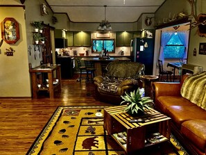 A cozy living room with a sofa, coffee table, and patterned rug.