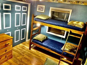 A room with a bunk bed, a dresser, a window, and a wall with geometric patterns. - Secluded Lakefront House Nestled in the Woods for an Unforgettable Adventure in Nature in Williford, Arkansas (Williford)