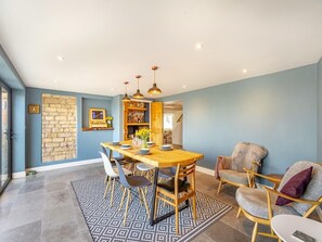 A dining area with a wooden table, chairs, and pendant lights. - Beautiful Country 3 Bed Escape, Warwickshire - Pass the Keys (Ufton)