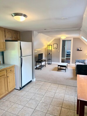 A compact living space with a kitchen, a dining area, and a seating area.