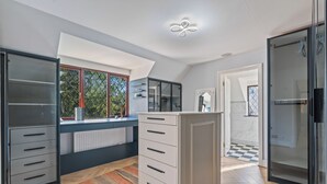 A modern kitchen with a built-in oven, a window with a view, and a wooden floor. - Family 6 Bed | Gated Parking, Sleeps 11, Bray (Bray)