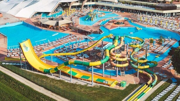 A large water park with multiple slides and pools, surrounded by a covered area with seating. - Terme Tuhelj Glamping Village: Vita Family Mobile Home for 6 People (Tuheljske Toplice)