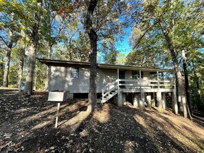 A cabin with a wooden deck and a staircase leading to a porch. - Cozy Waterfront Cabin with Private Pond Views and Outdoor Deck Near Zwolle, Louisiana (Zwolle)