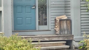 A house with a blue door, a number 31, and a small porch with steps.