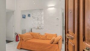 A room with a bed, a radiator, a fire extinguisher, and a door. - Apartment 'House Fede' with Sea View and Wi-Fi (Genoa)