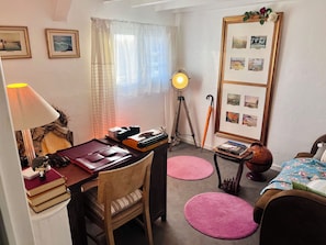 A cozy room with a desk, chair, lamp, framed pictures, and a bed. - Unique loft near Paris • Sleeps 25 • Giant Screen • Full privatization (Château-Thierry)