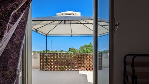 A covered outdoor area with a patterned fence and a white canopy. - Il Casolare Siciliano (Palmeri - Ferrante)