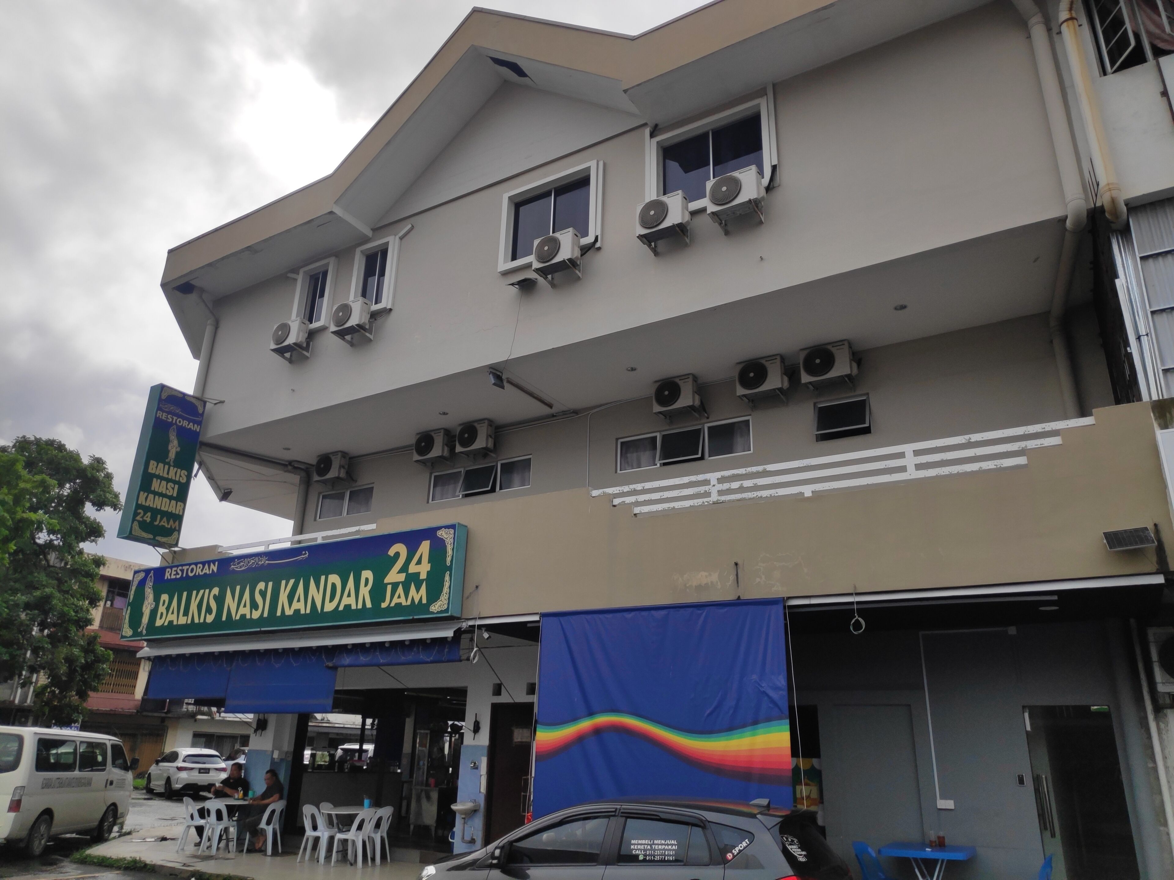 A multi-story building with a restaurant named 'Balkis Nasi Kandar Jam' on the ground floor. There are multiple air conditioning units installed on the exterior.